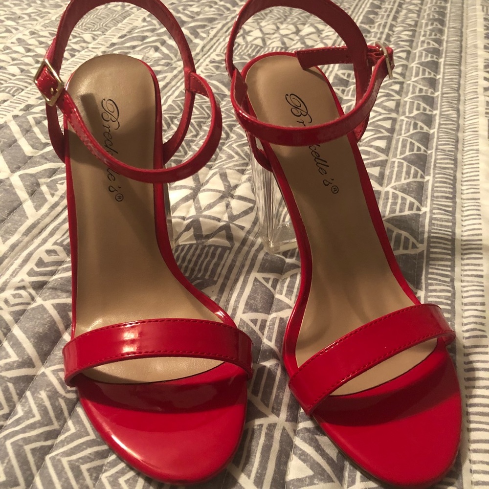 red patent leather shoes with transparent heels.